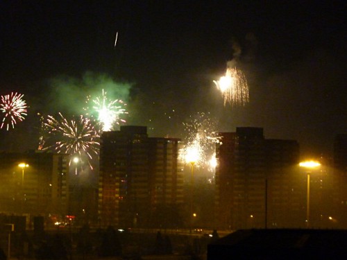 Fireworks between the tall buildings of  Beijing