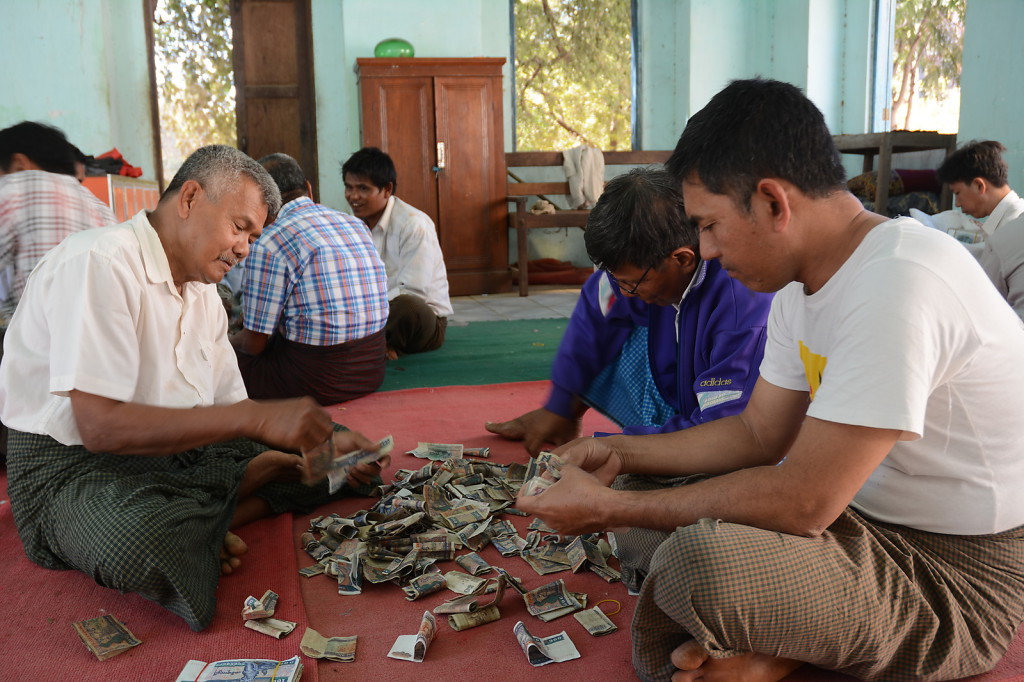 Counting donated money in Bagan